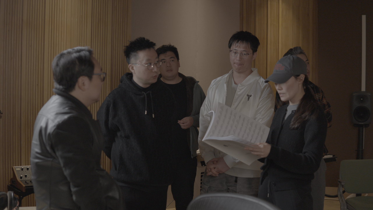 Studio team reviewing a score during production