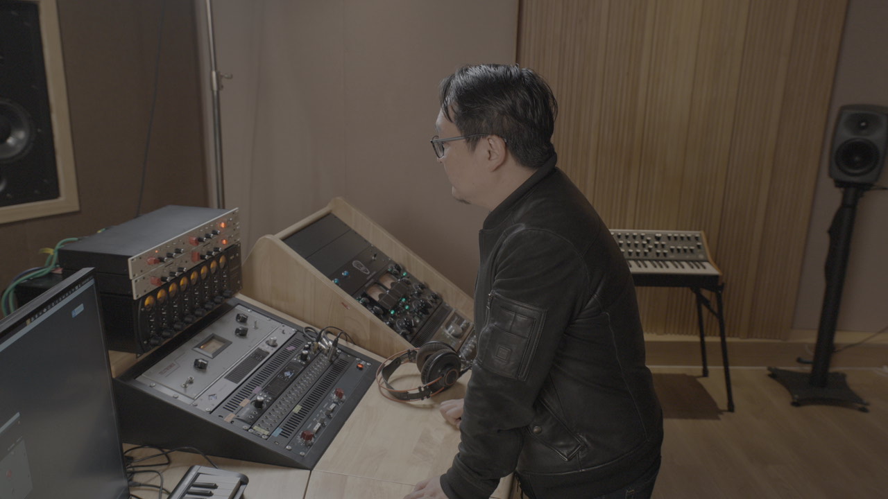 Engineer working at the studio mixing console